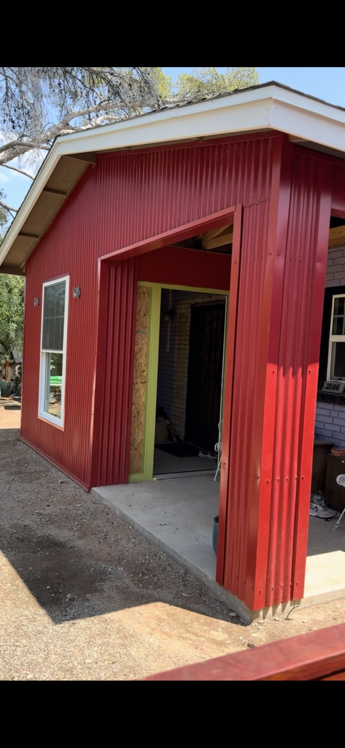Contemporary home with white and metal siding panels